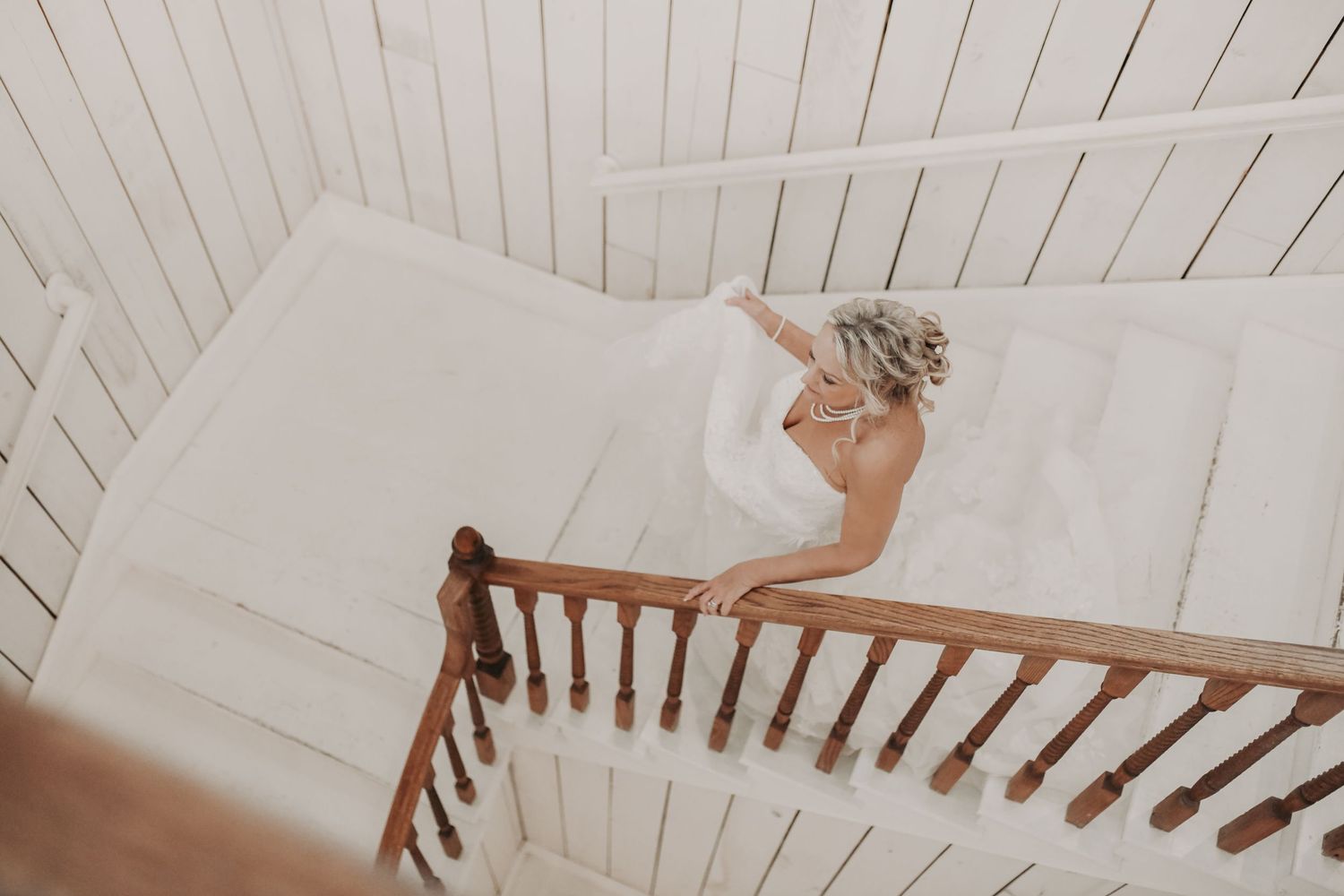 Romantic bridal portrait featuring a sleeveless lace wedding dress and pearl details