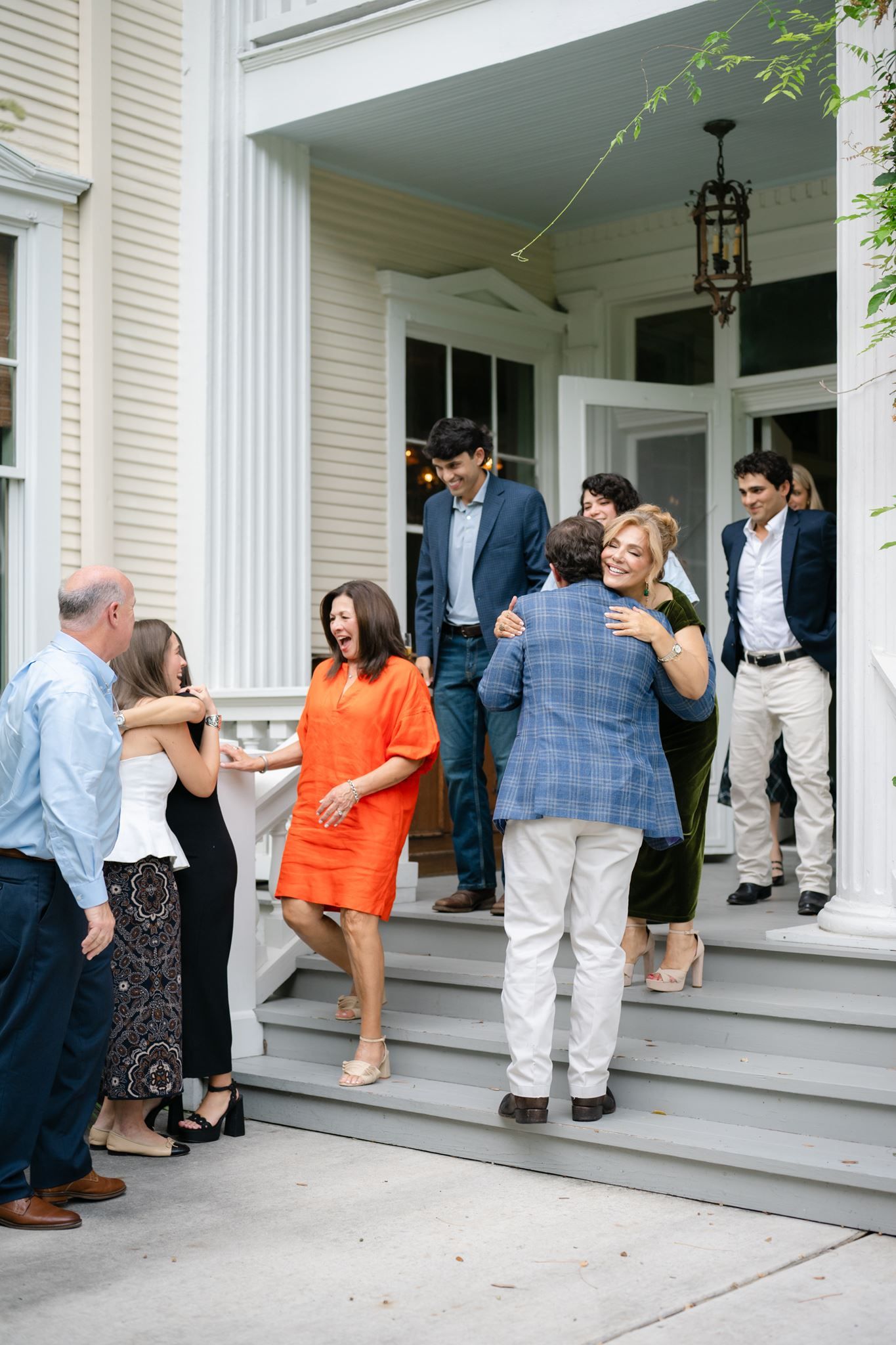 Family and friends embracing the newly engaged couple.