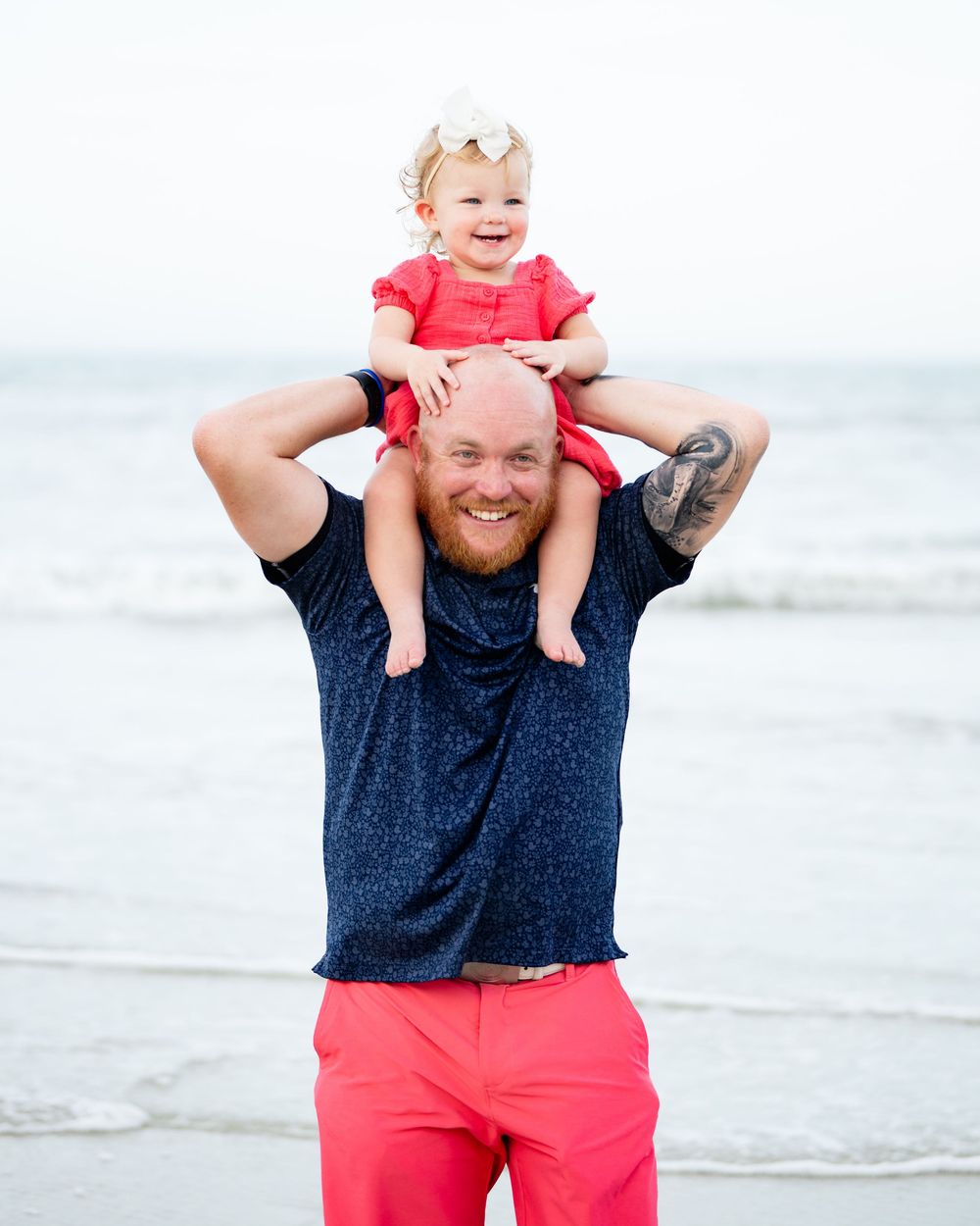 A collection of beach portraits showing joyful moments between parent and child in coordinating coral and navy outfits.