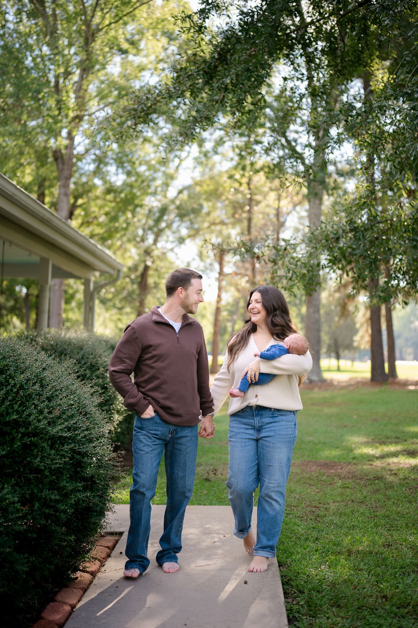 New parents enjoying a quiet moment with their newborn son outside their Willis home