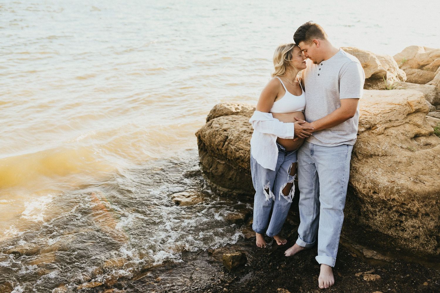 Sunset maternity photography at Lake Grapevine with expecting parents by the water