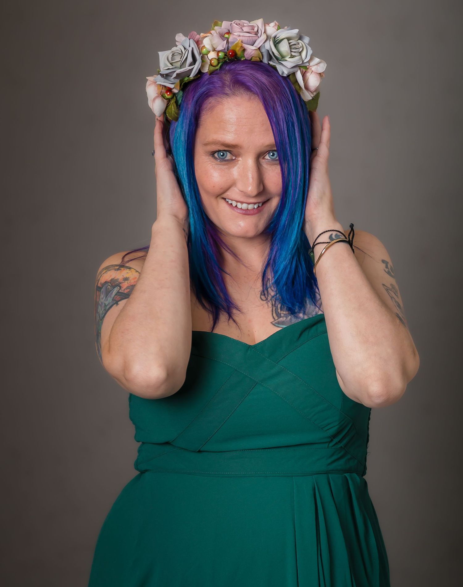A portrait showcasing vibrant blue and purple dyed hair against a dark background.