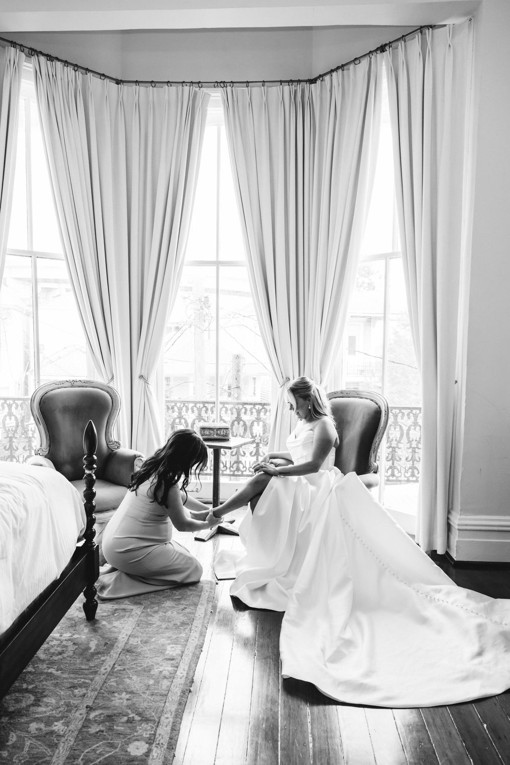 Artistic black and white photo series showing ethereal flowing fabric movement in an elegant room with tall windows.