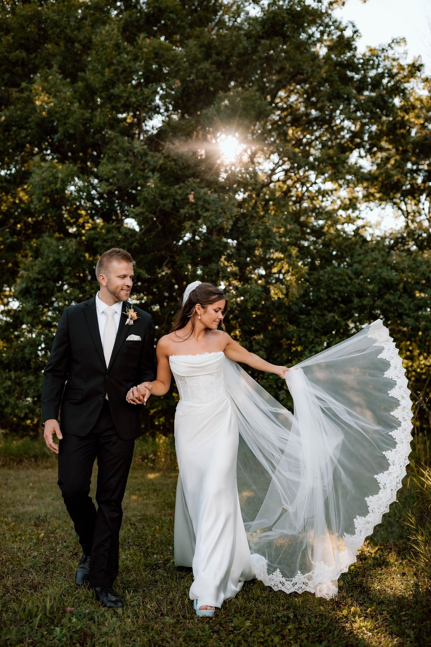 bride and groom walking while having movement with dress