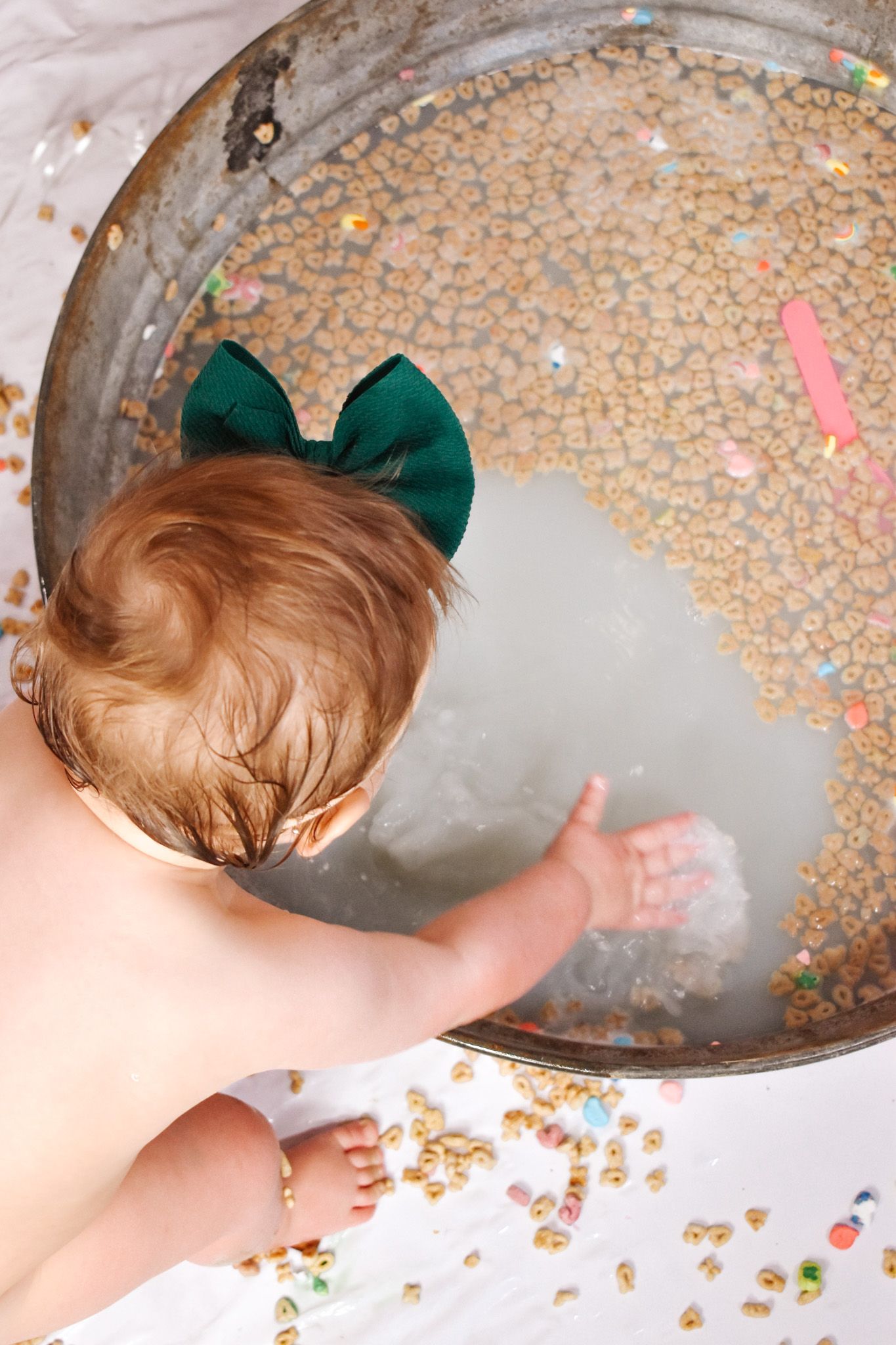 A creative breakfast setup with cereal scattered in a rustic bowl and colorful decorations.
