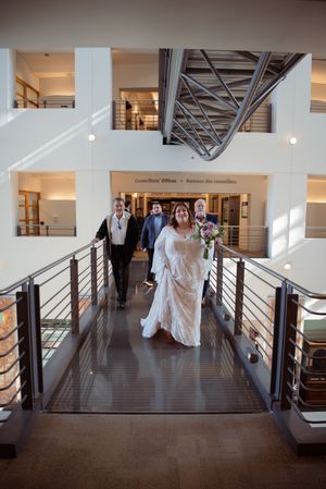 Modern indoor venue with white walls and dark wood floors featuring contemporary architectural details.