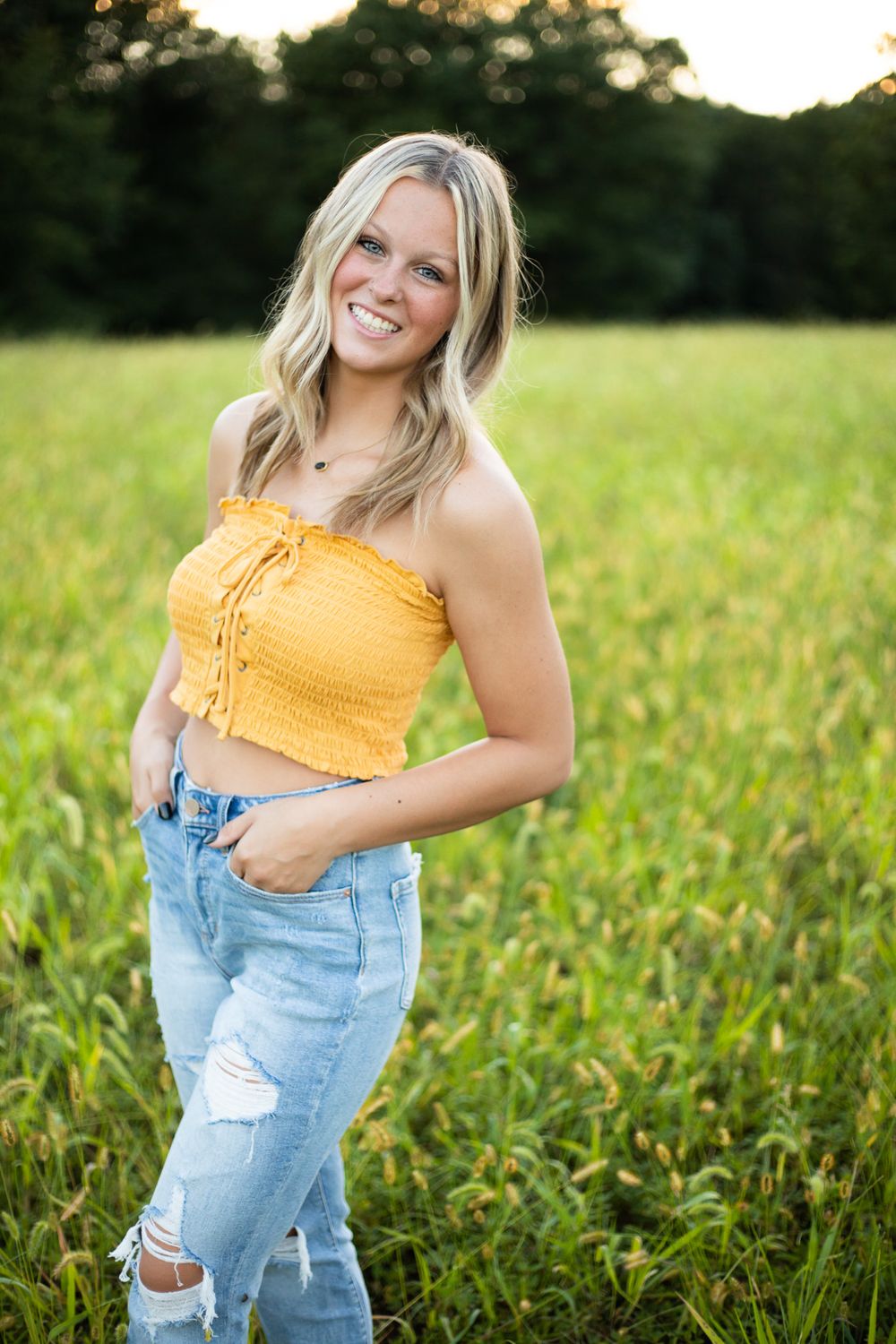 Summer outdoor photos in yellow smocked top and distressed denim.