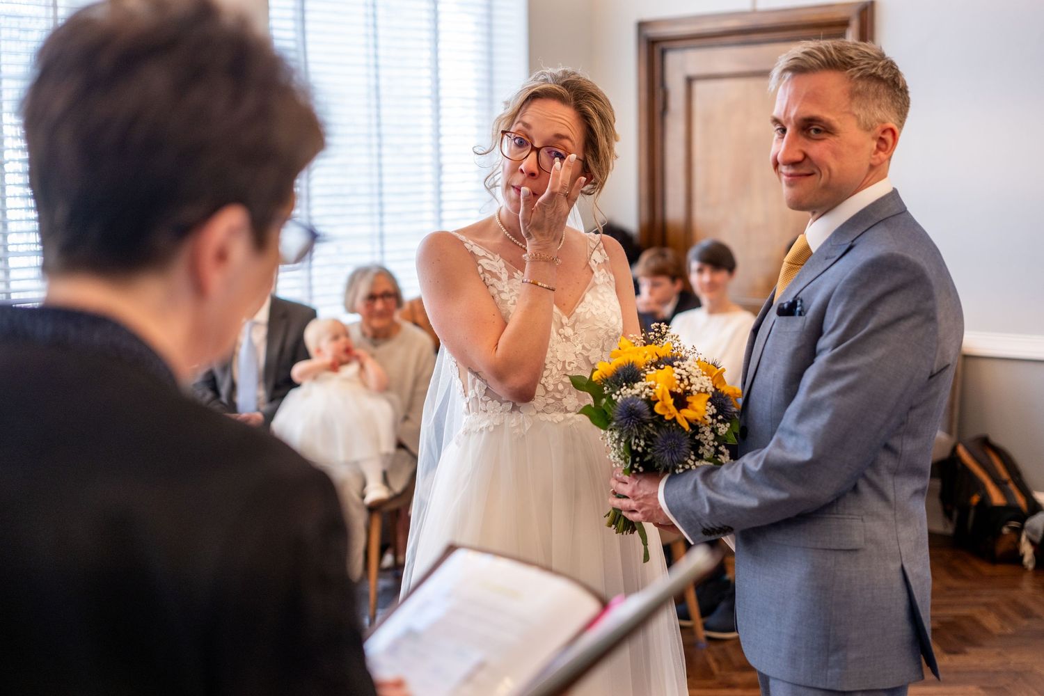 A bride sheds a tear during a wedding ceremony in Islington