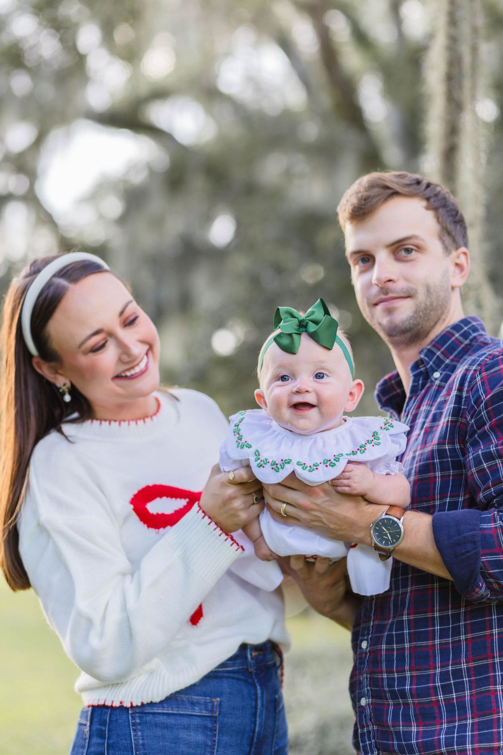 Cheerful outdoor family moment captured under Spanish moss trees.