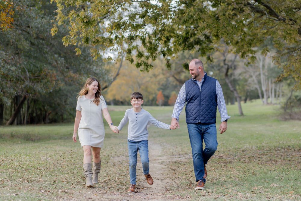 A joyful walk together through an autumn park holding hands on a crisp fall day.