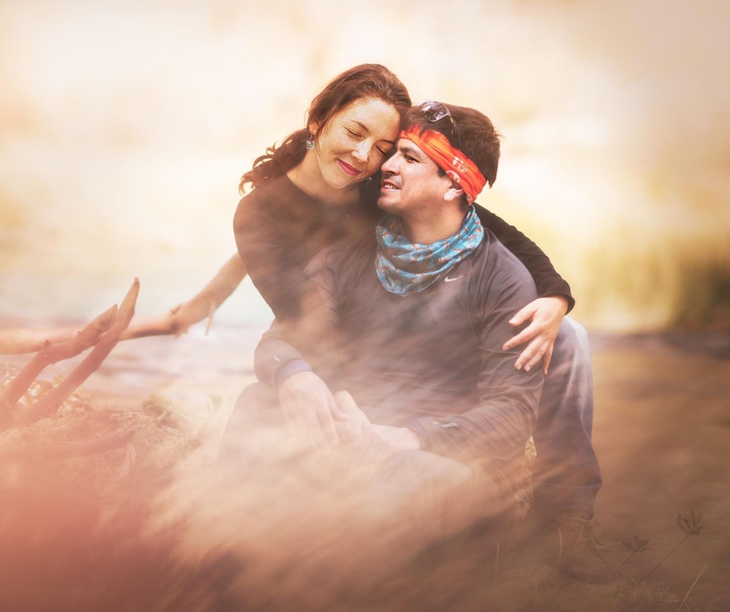 A romantic sunset portrait in a wooded area with golden light streaming through trees.