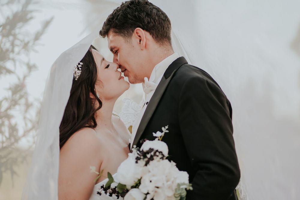 A romantic wedding couple shares tender moments in a series of four connected portraits.