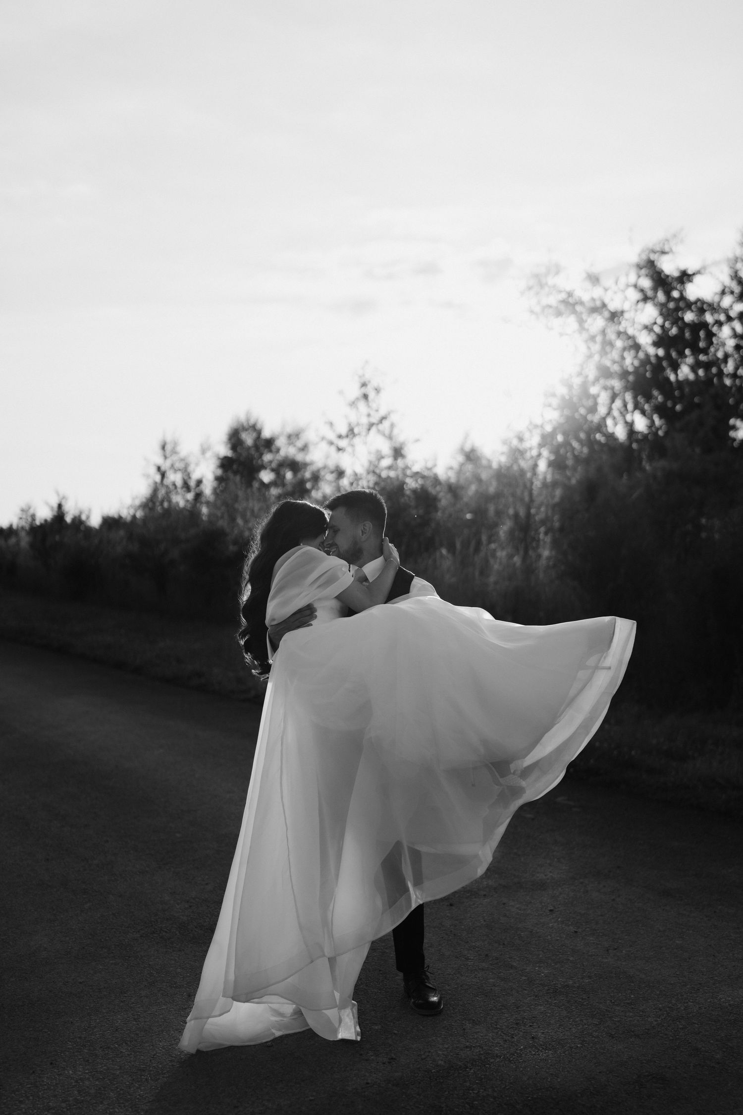 bride and groom kissing during sunset at yardspace old gore Cirencester