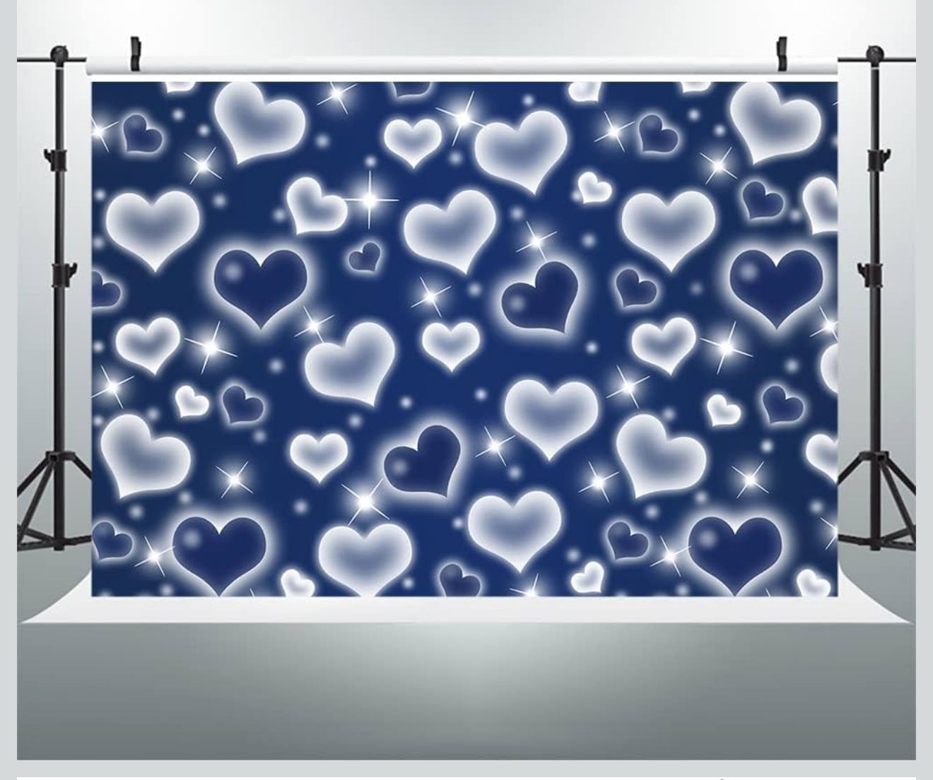 A navy blue backdrop decorated with floating white glowing heart patterns creating a romantic atmosphere.