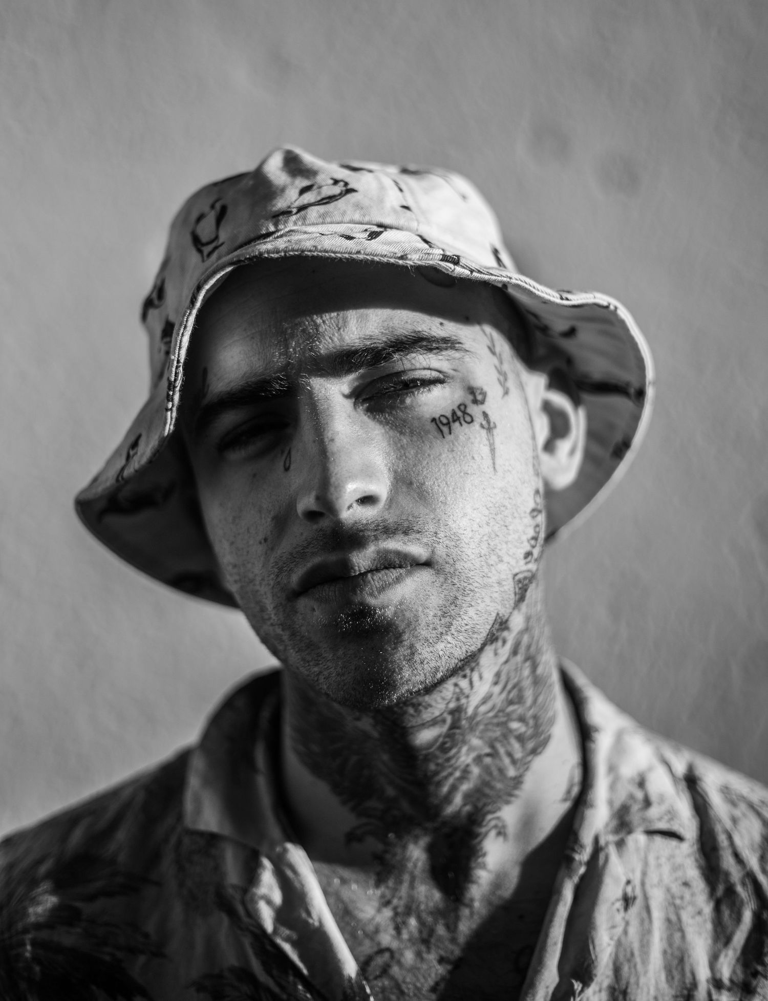 A black and white portrait series showing a person in a hat with sweat and dirt on their face.