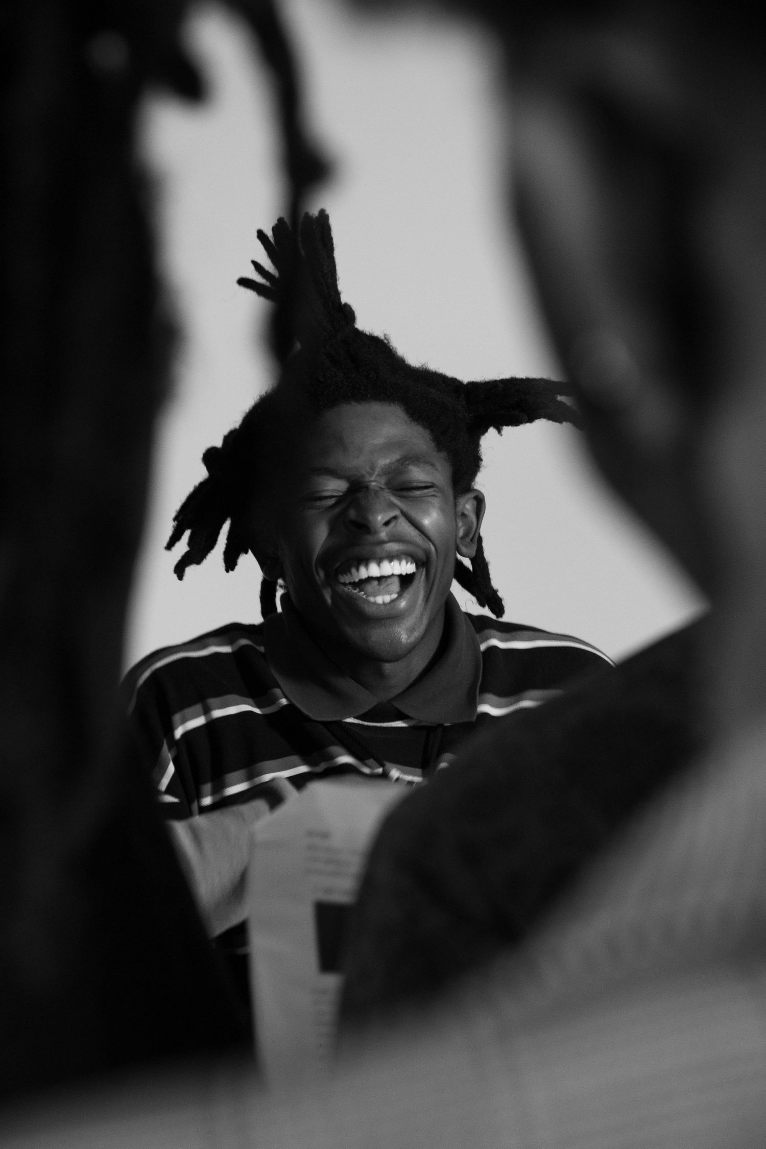 A black and white photo series showing expressions of joy and laughter in an intimate candid moment.