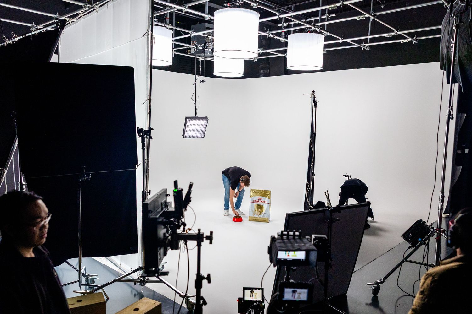 Professional photography studio setup with lighting equipment and dark backdrop.