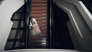 A bride and groom pose at the Texas Capitol staircase.