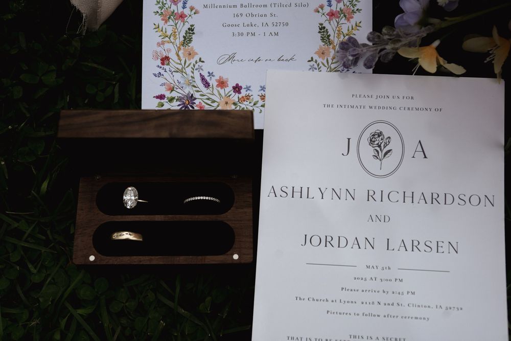 Elegant floral wedding invitation with botanical details and couple's names.