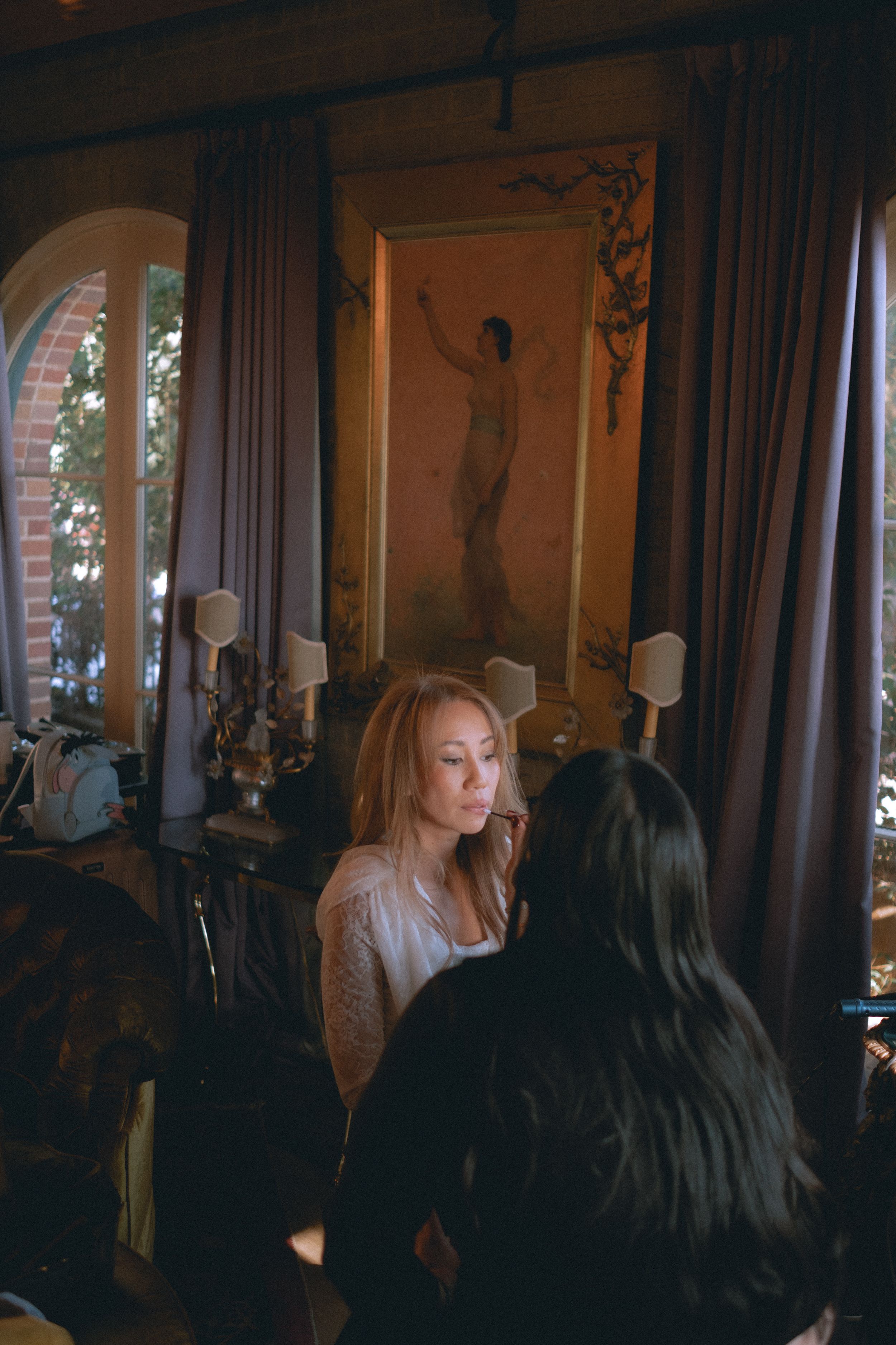 Behind-the-scenes wedding preparation in an ornate room with vintage decor.