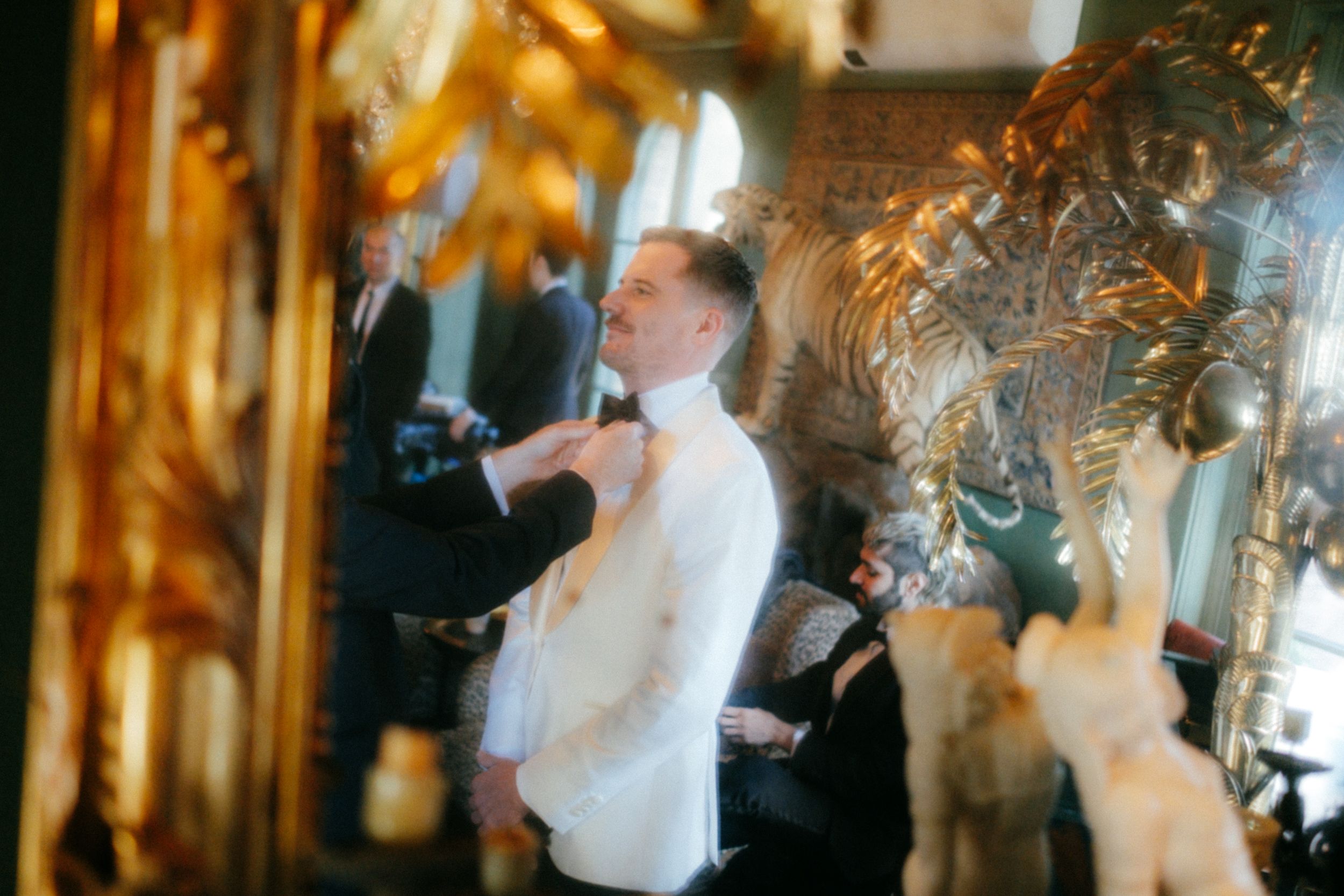 Motion-blurred candid moment during wedding celebrations in an elegant gold-detailed venue.