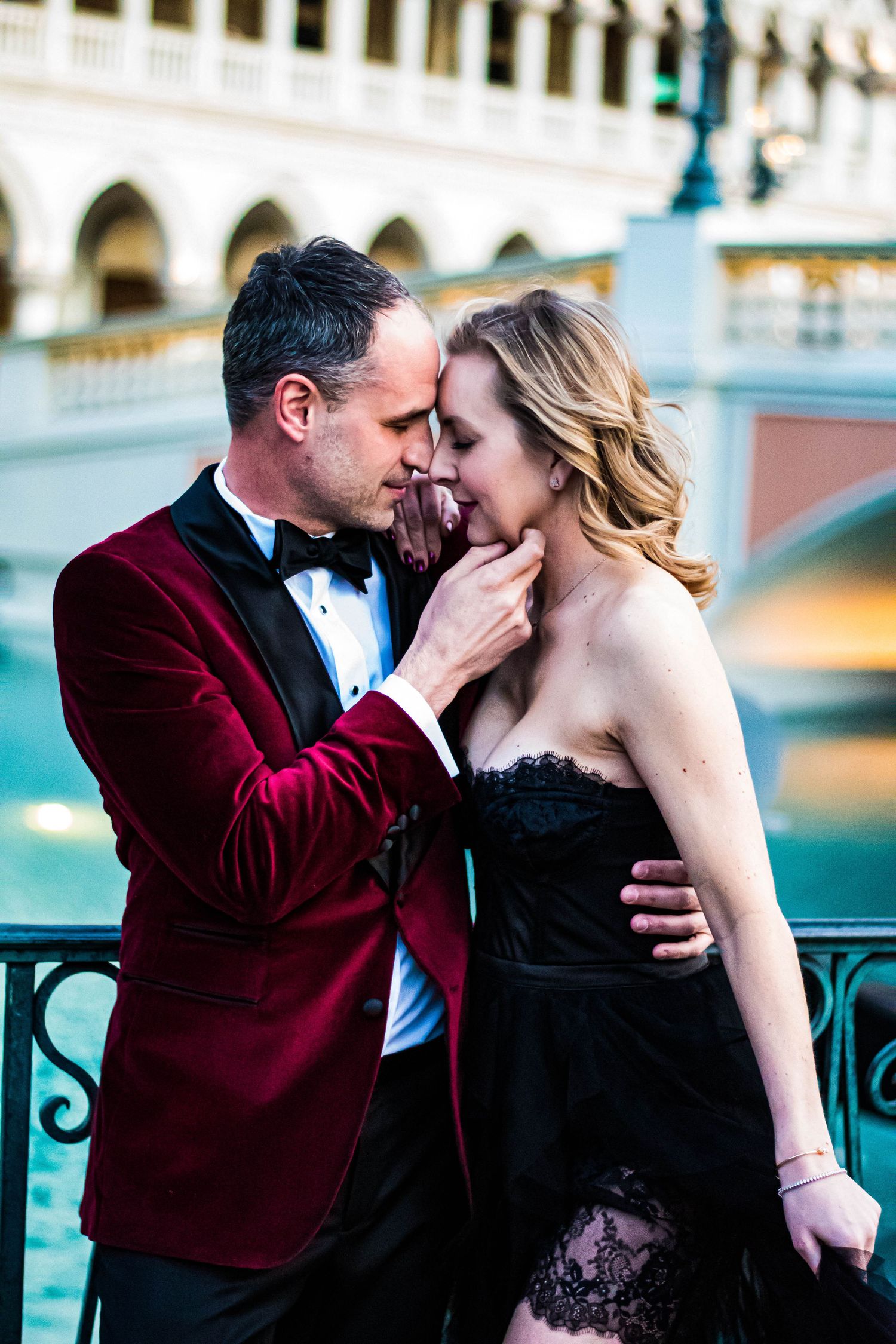 Elegant couple in formal attire sharing intimate moment at The Venetian Las Vegas.