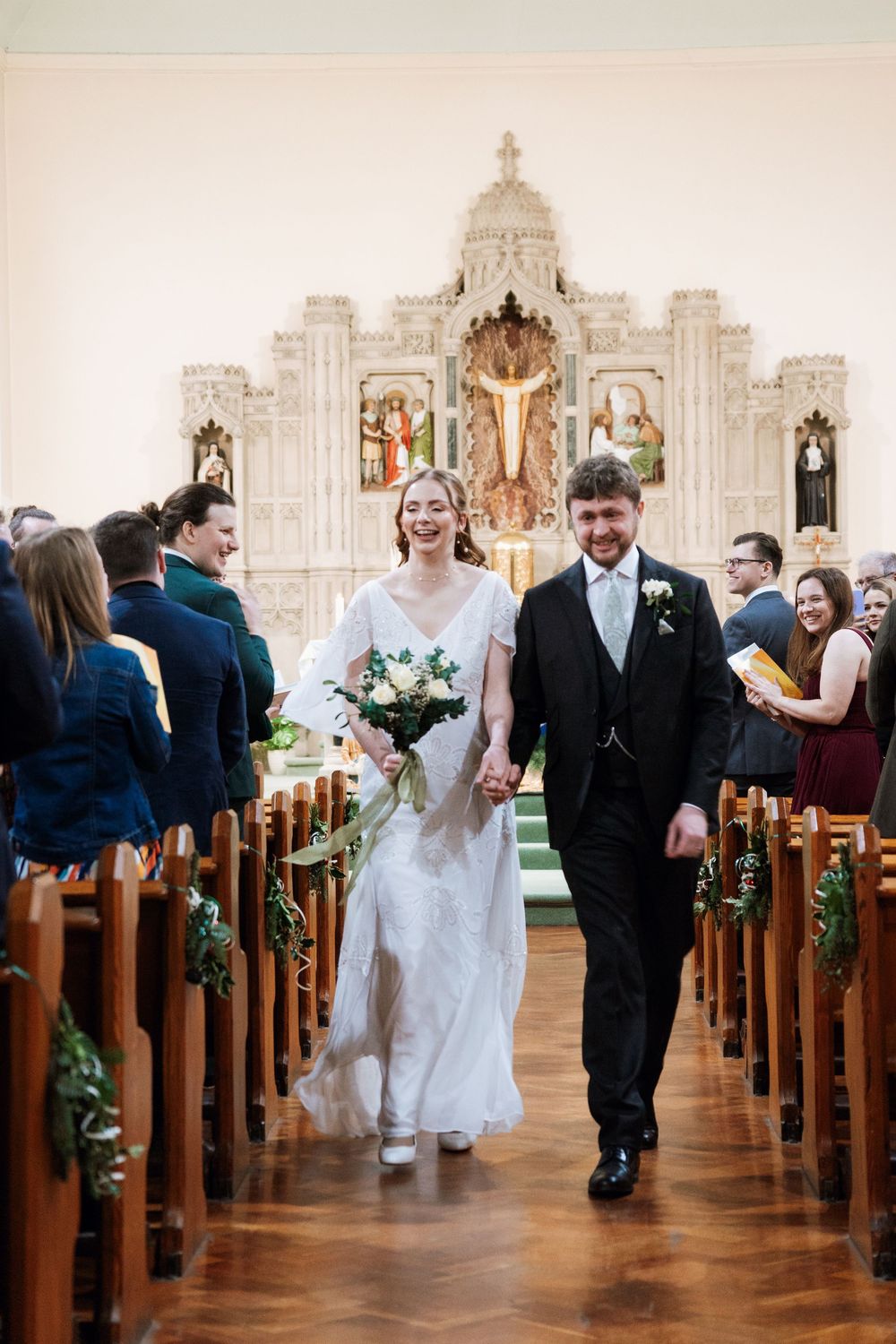 Bride and groom ceremony walking down the aisle after getting married, flower bouquet, church wedding, Preston, lancashire