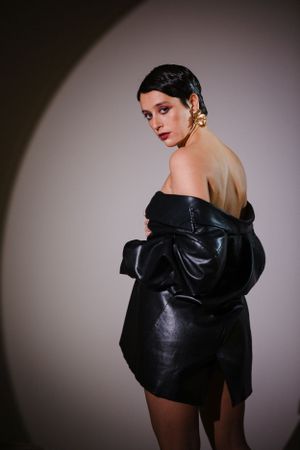 Moody fashion photograph featuring black leather statement piece.