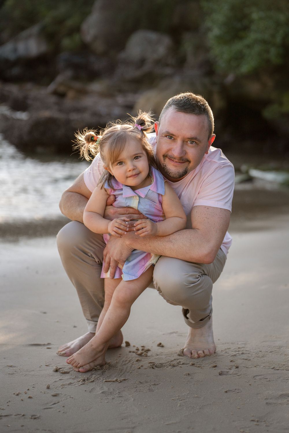 Dad hugs daughter during a family photoshoot at Collins Flat Manly during golden hour