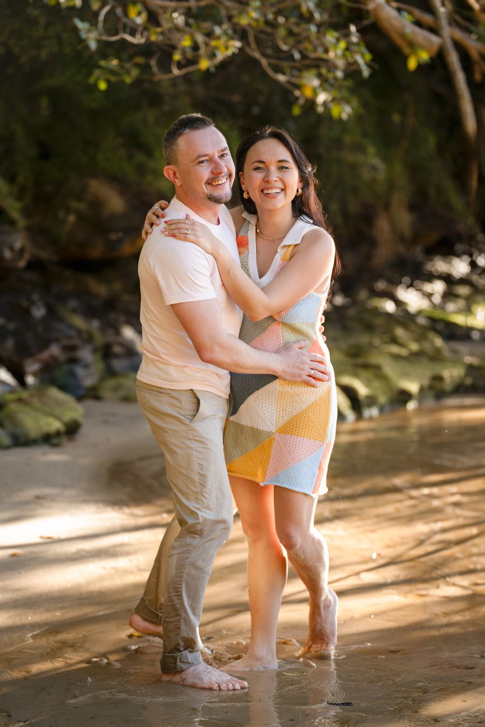 Happy couple sharing a joyful moment during a photoshoot at Manly