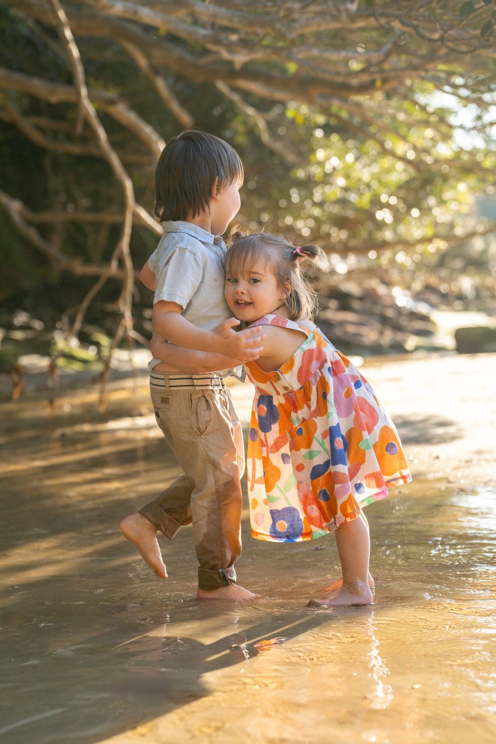 Toddler sister hugging her toddler brother during a family photoshoot at Manly, Sydney