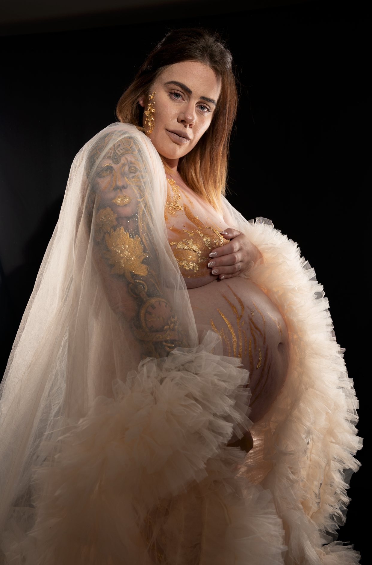 Pregnant woman laced in gold flake