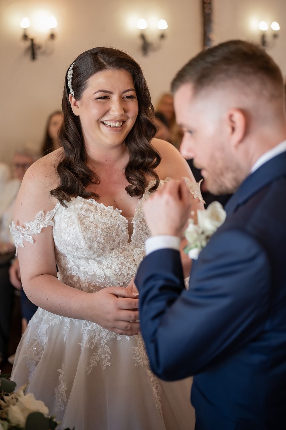A heartfelt moment between newlyweds sharing laughter during their wedding ceremony.