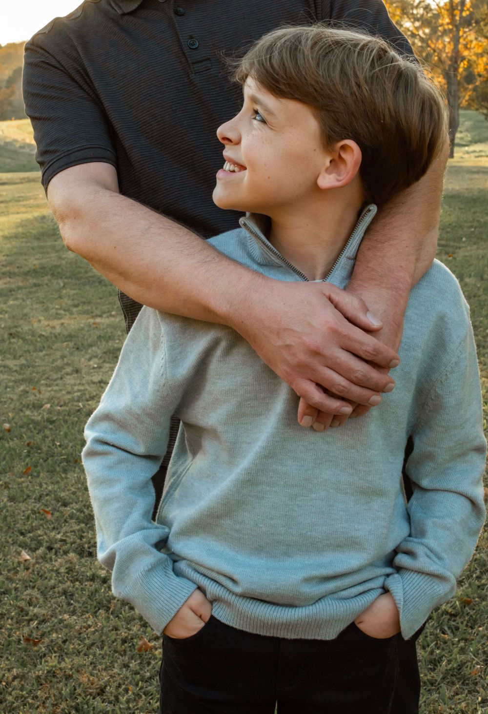 child looking at father smiling for a family photo session