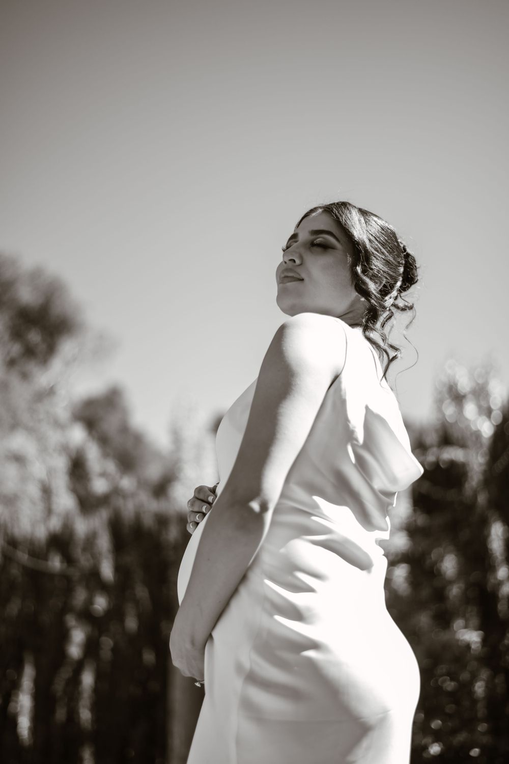 Artistic black and white silhouette of a figure in white against a natural backdrop.