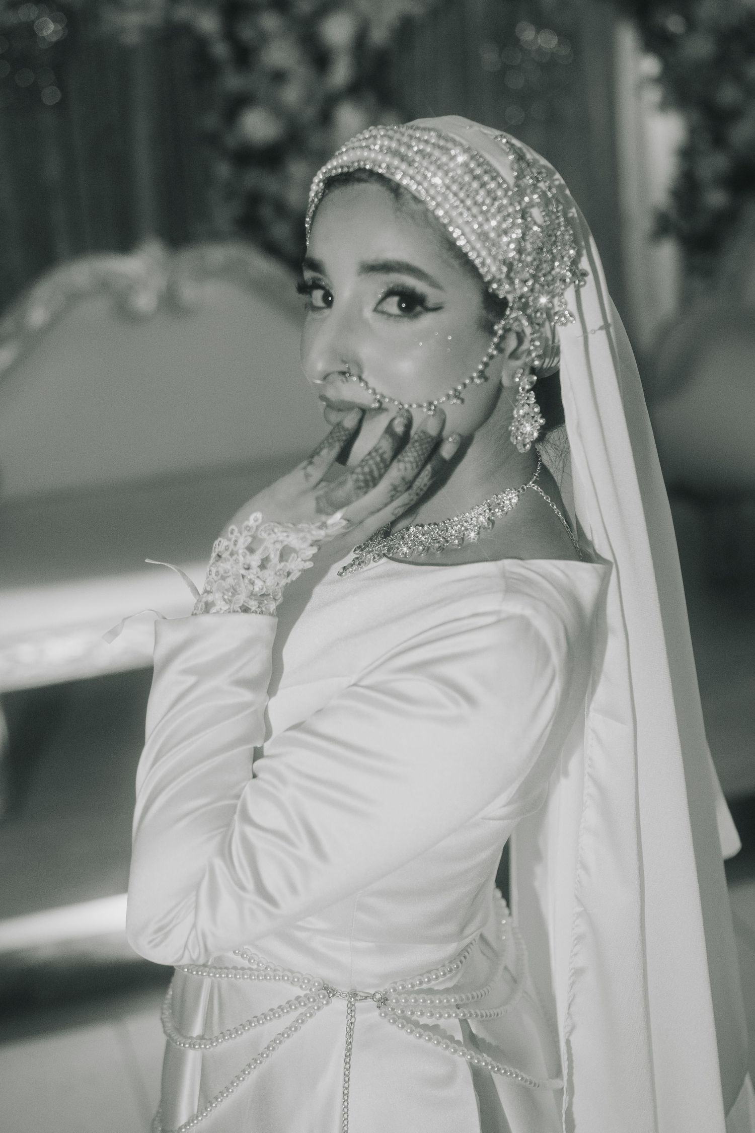 Black and white portrait of bride in traditional modest wedding attire.