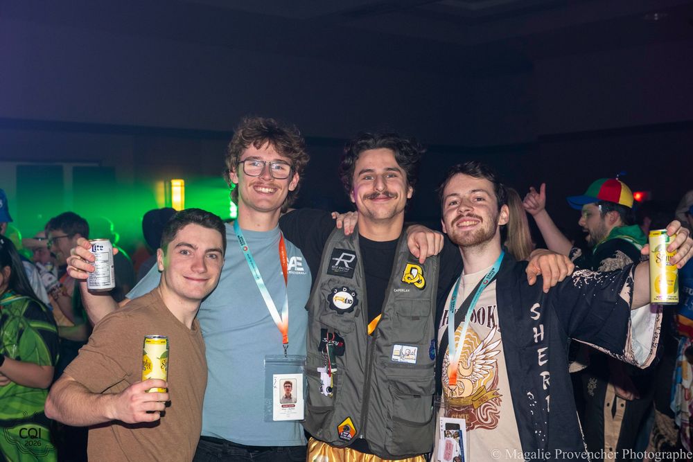 Group of friends enjoying drinks and socializing at a casual gathering in dimly lit setting.