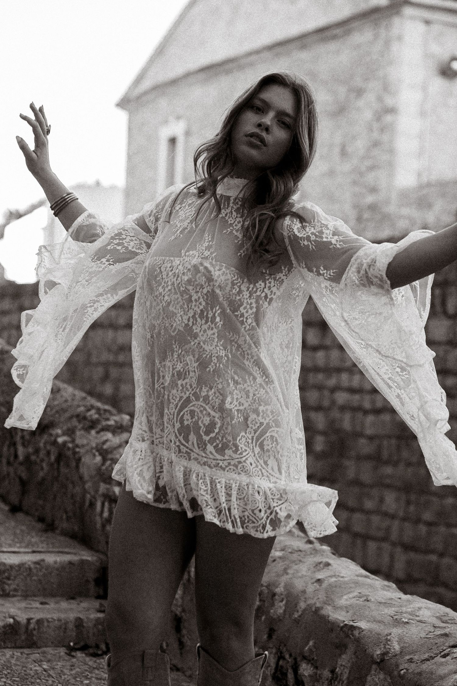 Black and white fashion sequence capturing dynamic poses in a white lace top.