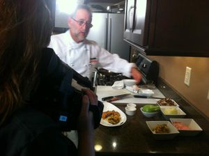 Professional chef preparing and plating food in a kitchen setting.
