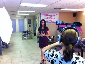 Video production setup in studio with lighting equipment and backdrop.