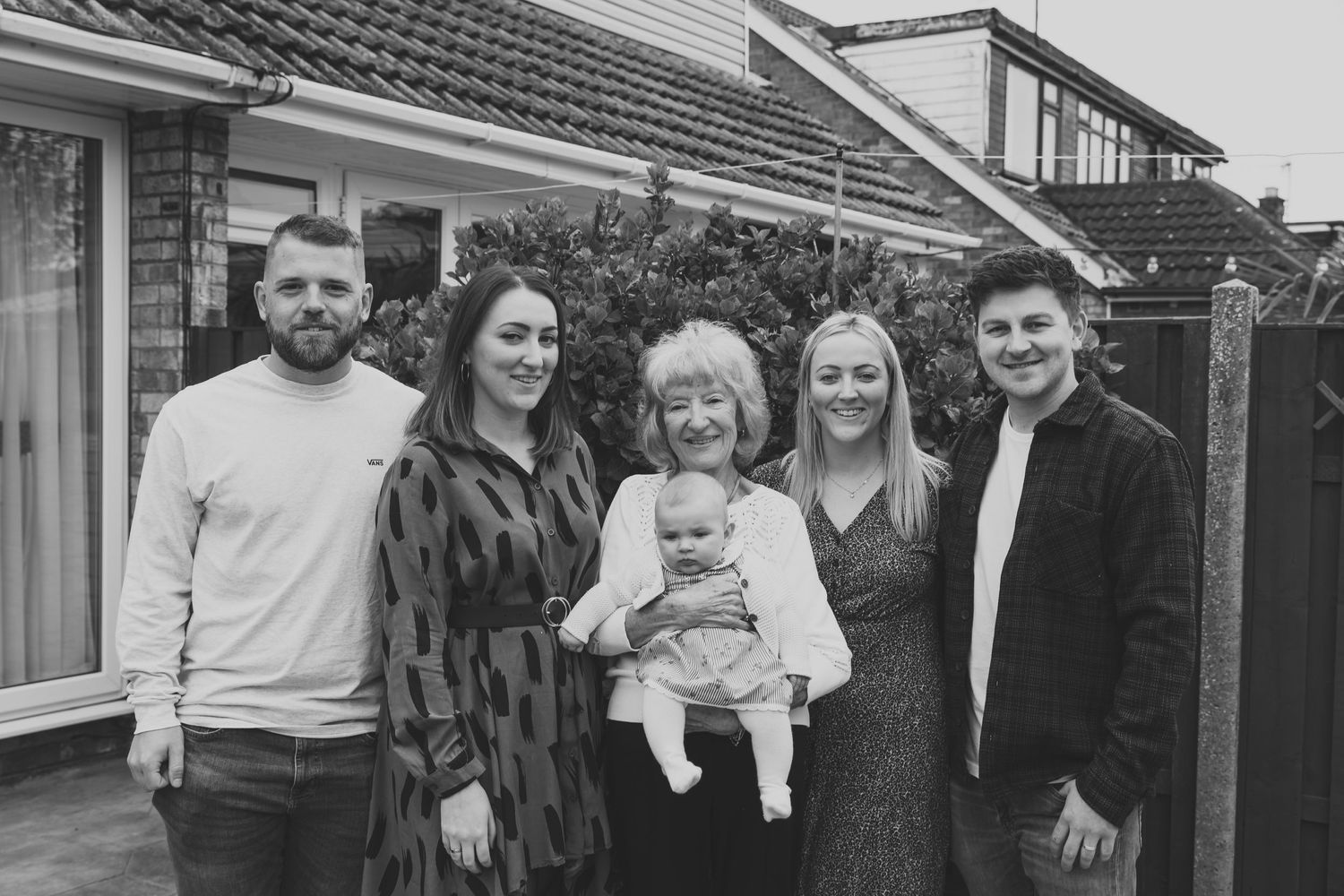 Outdoor family gathering with multiple generations posed in front of house. Photographer. Hull. East Yorkshire. Photography