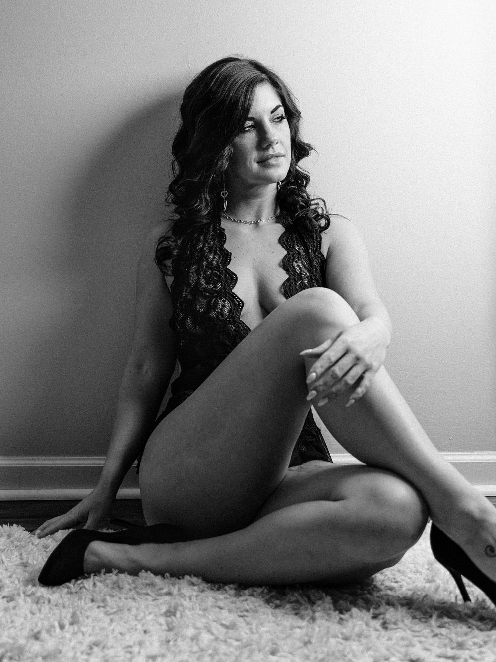 Boudoir portrait of a Knoxville woman leaning on a wall taken by dandridge TN boudoir photographer for her birthday photo session