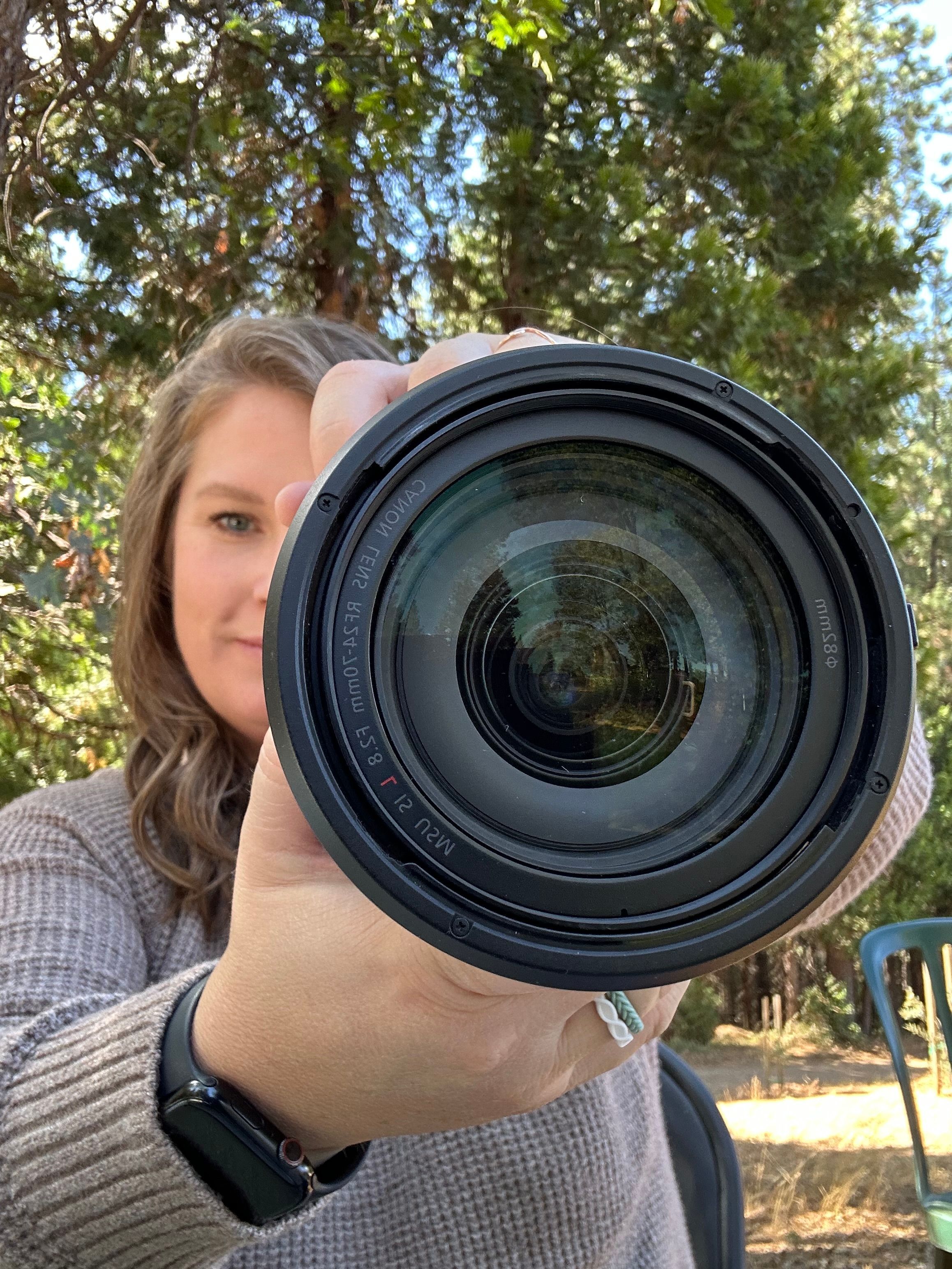 Krystal Roina, a professional portrait and wedding photographer in the Sacramento area, takes a photo with her camera.