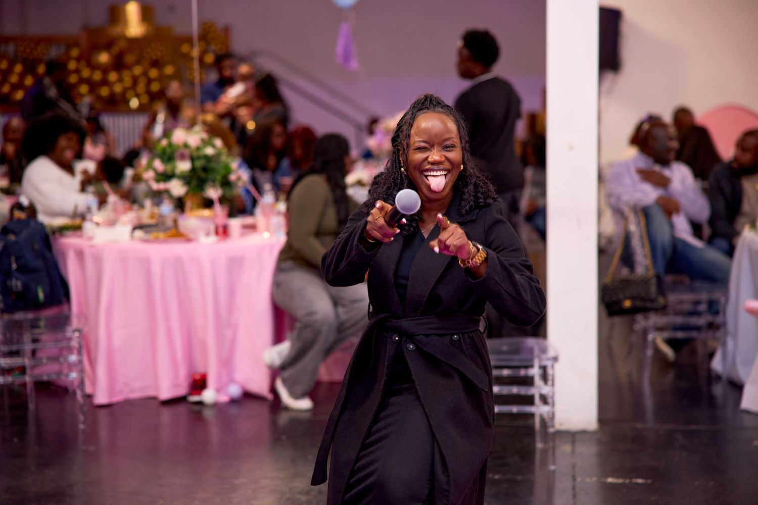 Guest in black formal attire enjoying a celebration at an elegantly decorated reception venue.