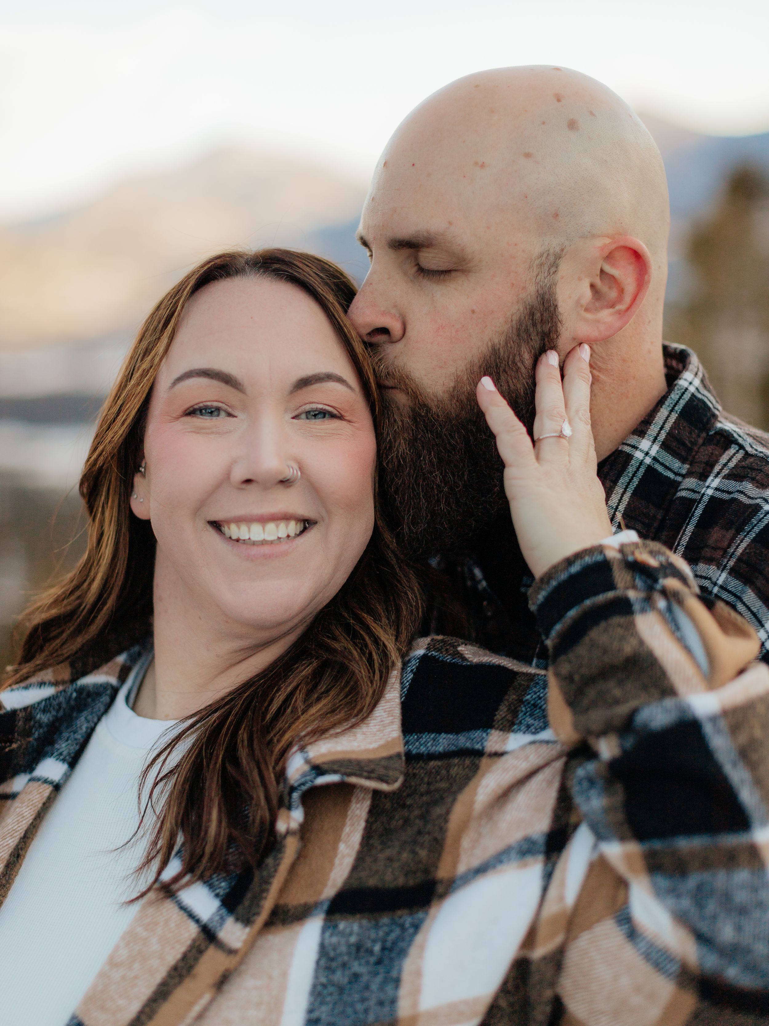 A romantic couple shares tender moments in a series of candid outdoor photos showing affection and laughter.
