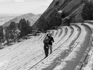 Snow-covered concrete steps in a mountainous amphitheater create dramatic curved lines against the winter landscape.