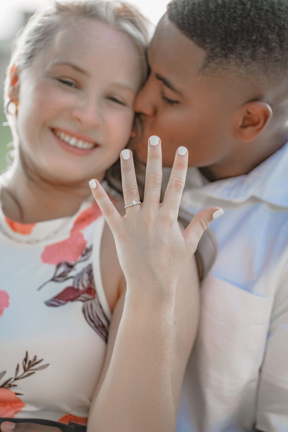 A close-up shot showing a hand with an engagement ring during an intimate moment.