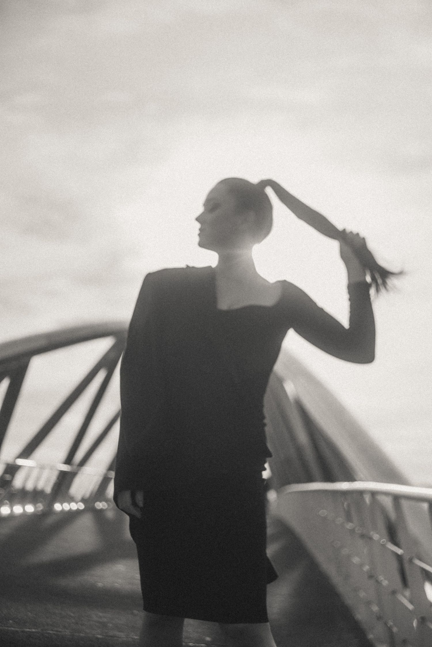 Silhouetted figure performs dynamic movements against a bright background in a cinematic sequence.