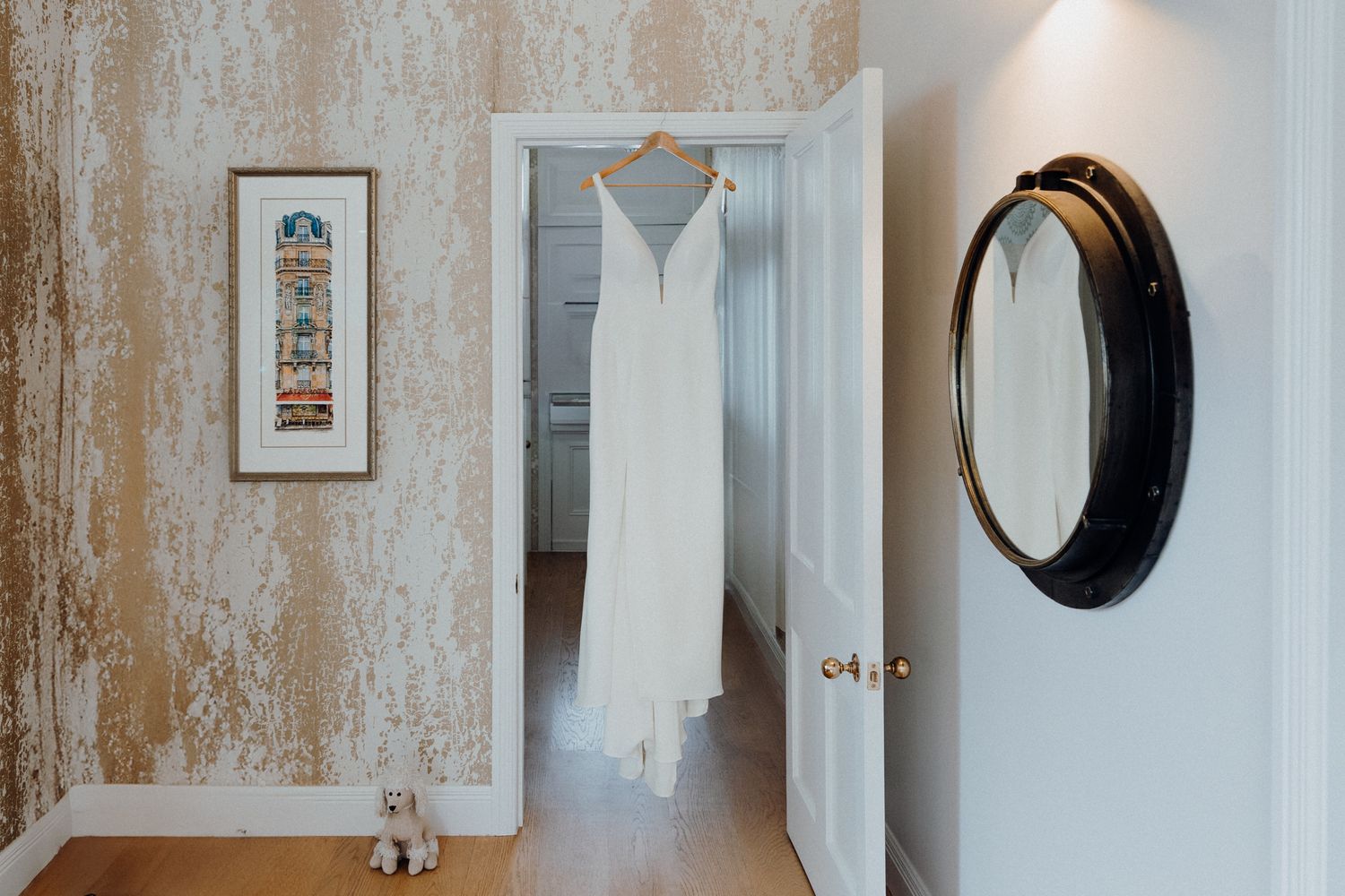 An elegant white wedding dress shot in a decorative wall art, captured by Apertured Media Auckland Wedding Photographer.