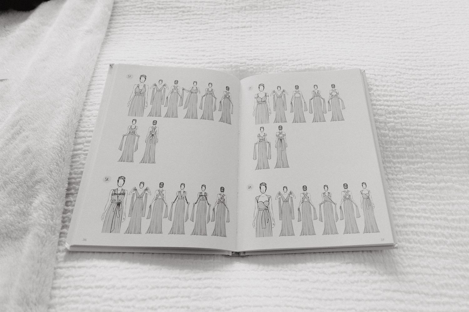 An open book displaying simple line drawings, captured by Apertured Media Auckland Wedding Photographer.